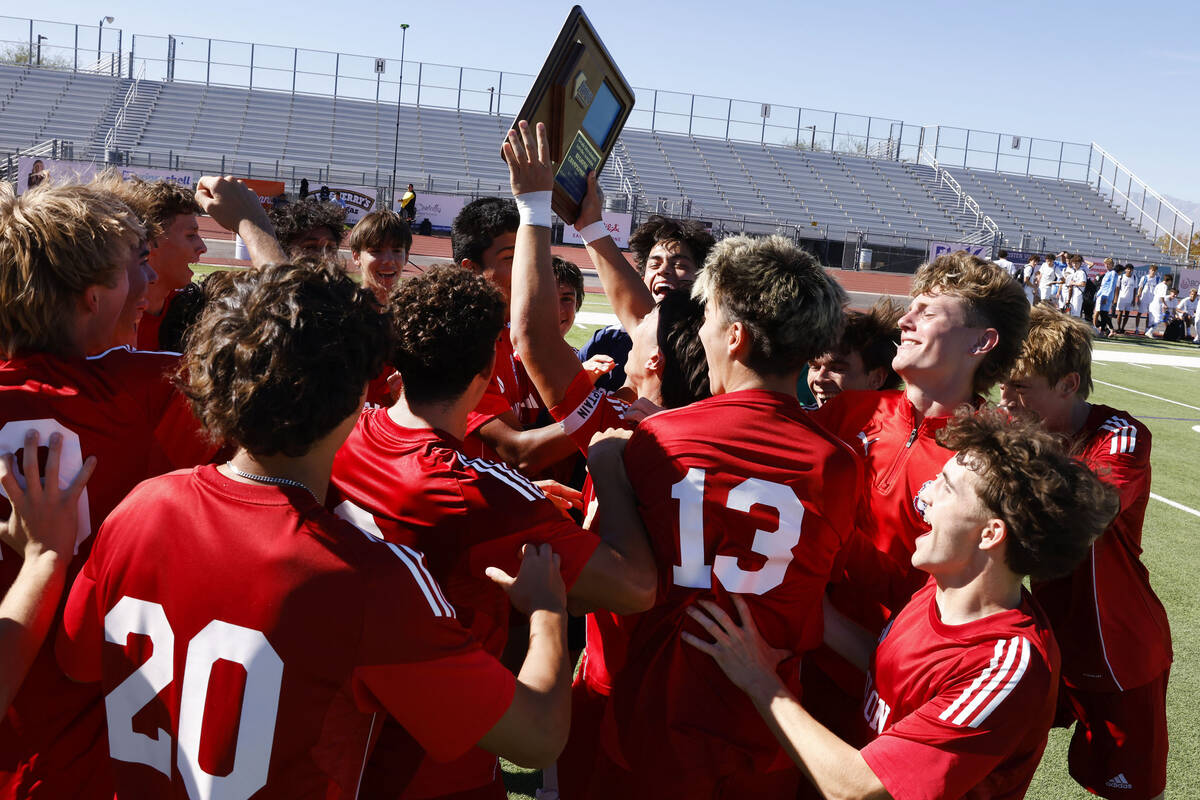 Coronado players celebrate their win in a Class 5A Southern Region boys soccer title game again ...