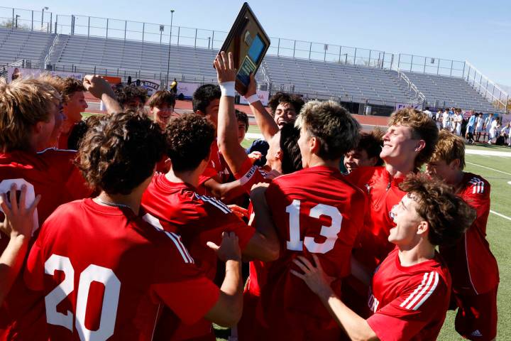 Coronado players celebrate their win in a Class 5A Southern Region boys soccer title game again ...