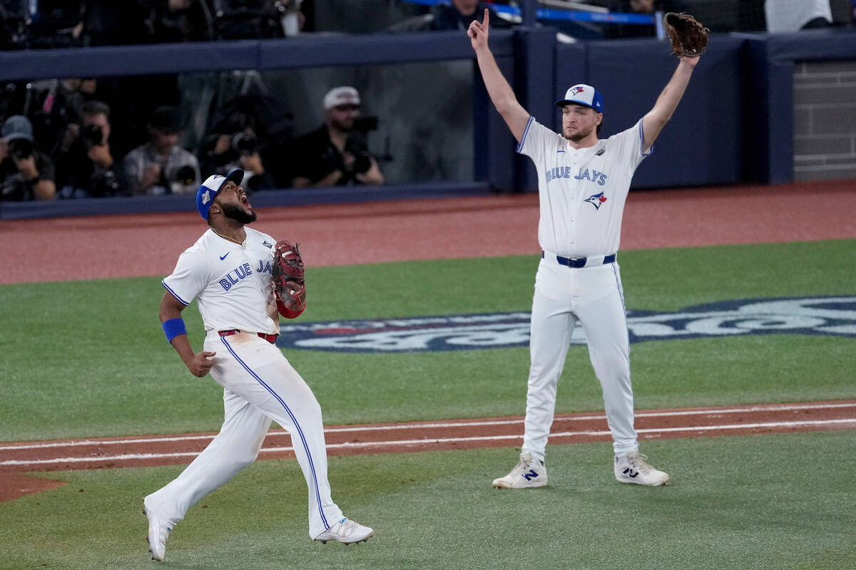 Toronto Blue Jays' Vladimir Guerrero Jr., left, and Trey Yesavage celebrate a double play ...