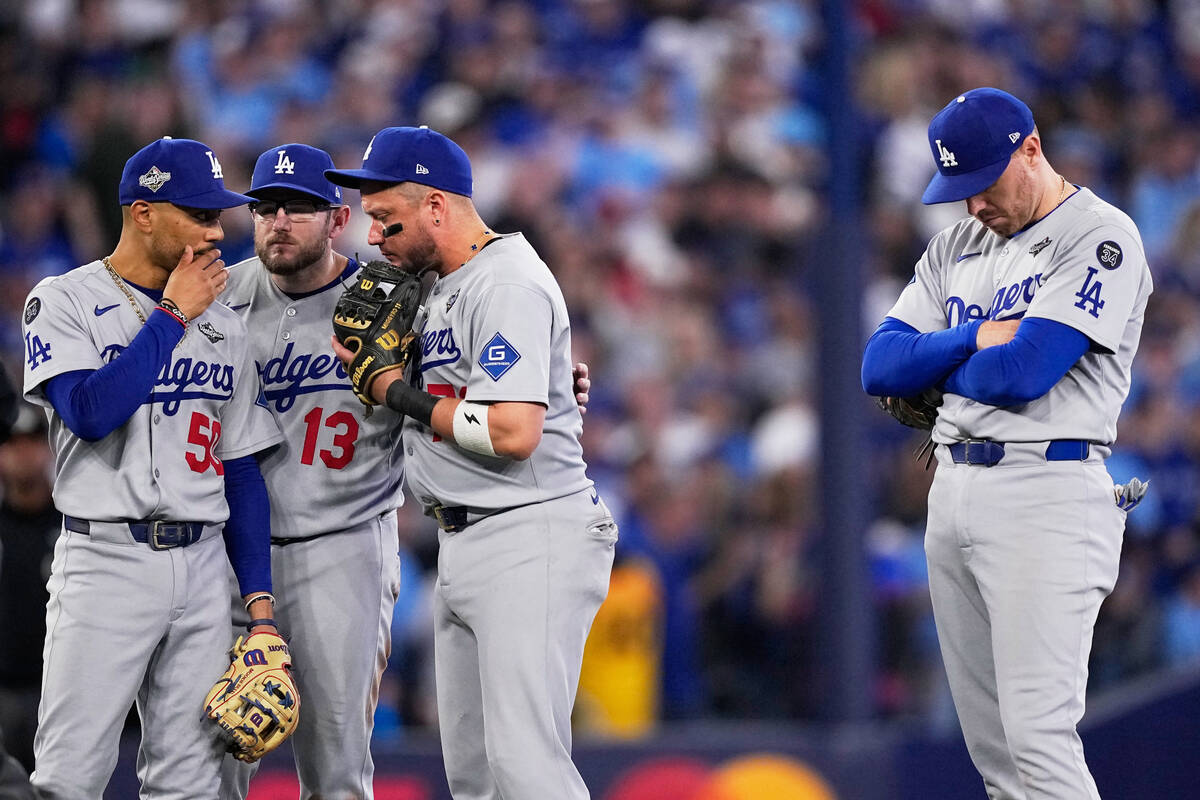Los Angeles Dodgers shortstop Mookie Betts, from left, Max Muncy, Miguel Rojas and Freddie Free ...