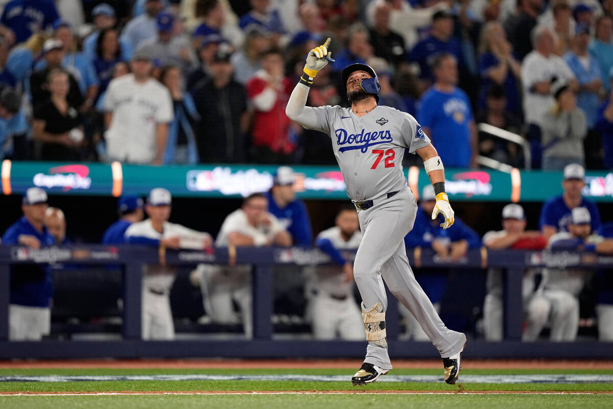 Los Angeles Dodgers' Miguel Rojas celebrates after a home run against the Toronto Blue Jay ...