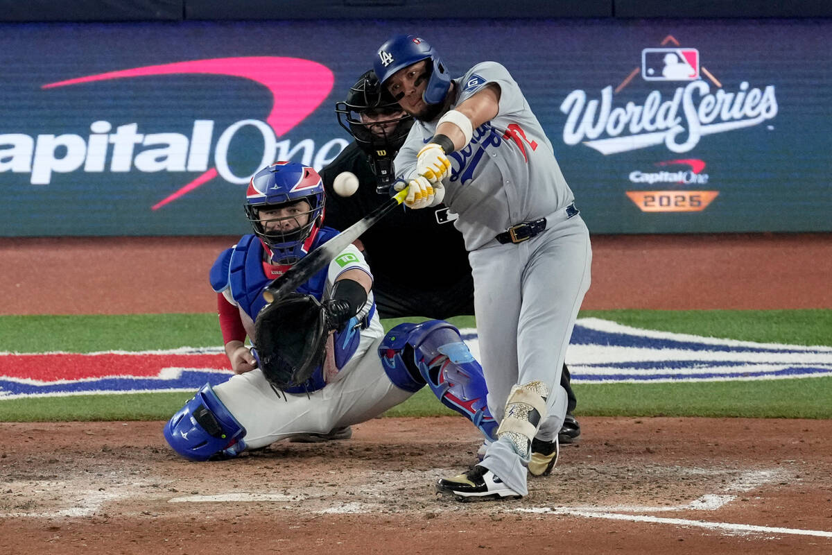 Los Angeles Dodgers' Miguel Rojas connects for a home run against the Toronto Blue Jays du ...
