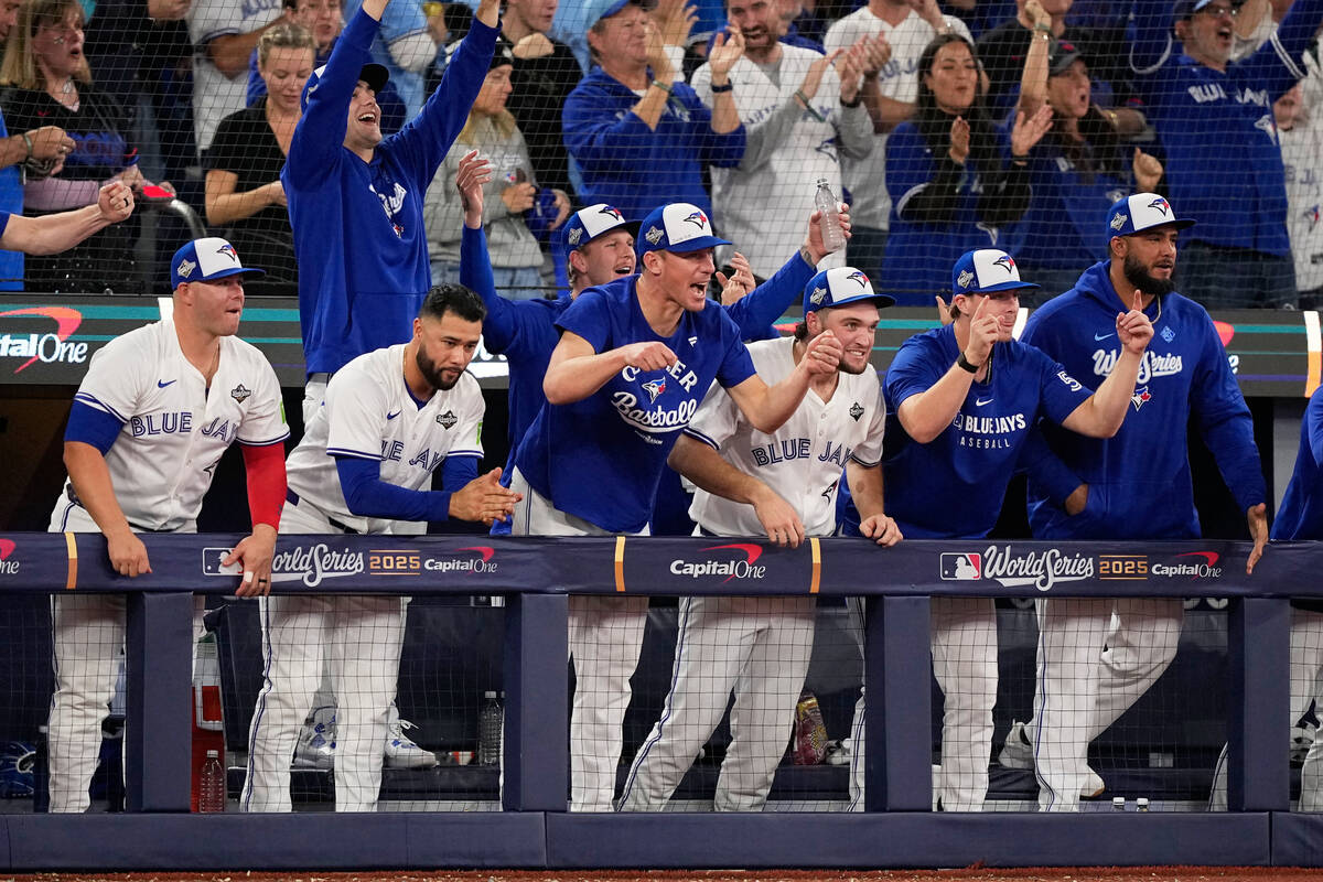 Members of the Toronto Blue Jays cheer after a double by Ernie Clement during the eighth inning ...