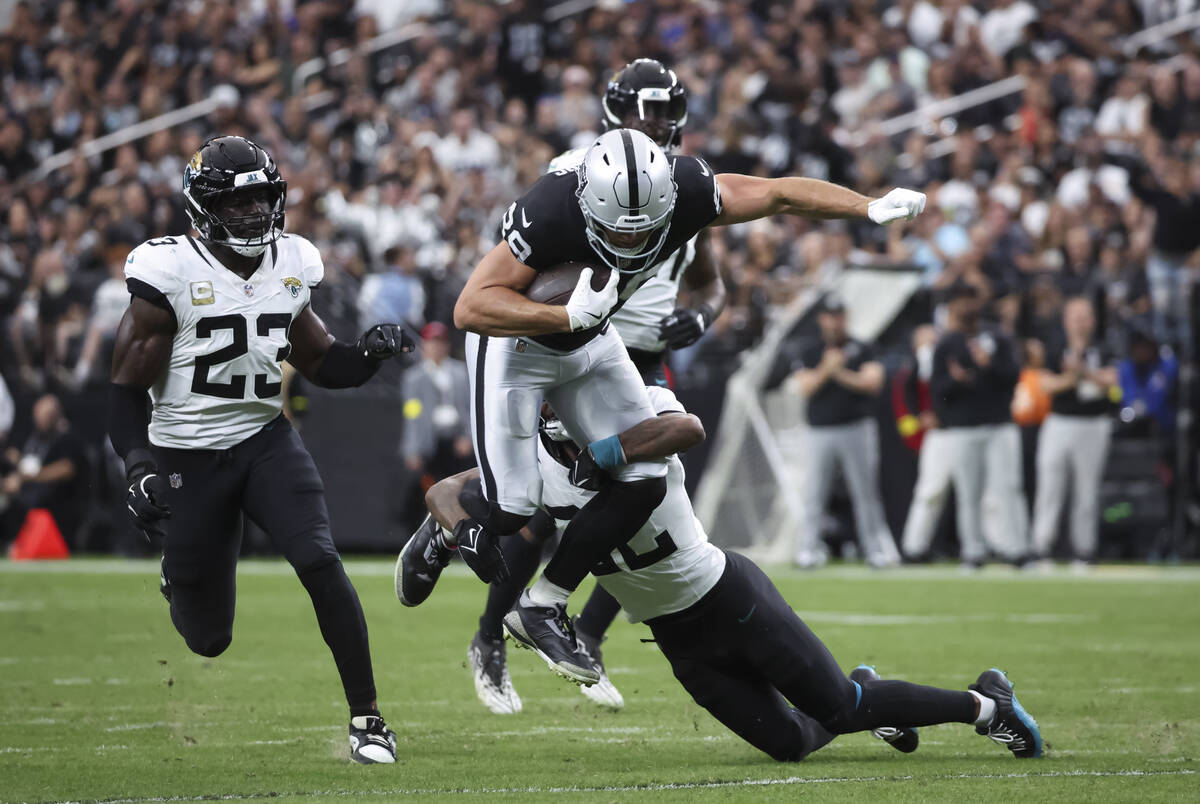 Raiders tight end Brock Bowers (89) gets tackled by Jacksonville Jaguars cornerback Jarrian Jon ...