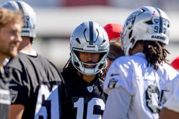 Raiders wide receiver Jakobi Meyers (16) moves into a huddle with center Jordan Meredith (61) a ...