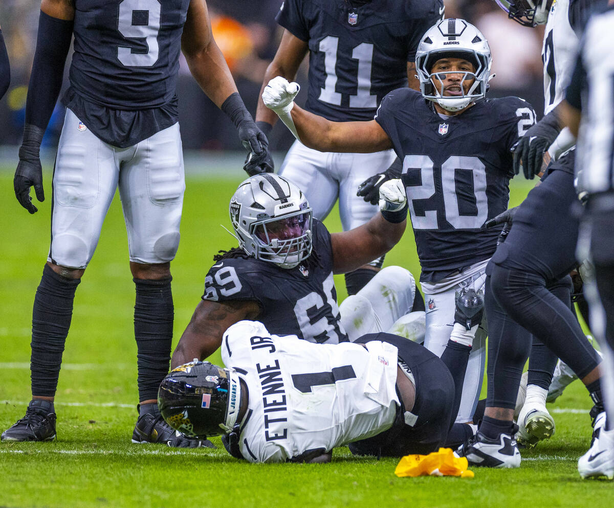 Raiders safety Isaiah Pola-Mao (20) celebrates a stop on Jacksonville Jaguars running back Trav ...