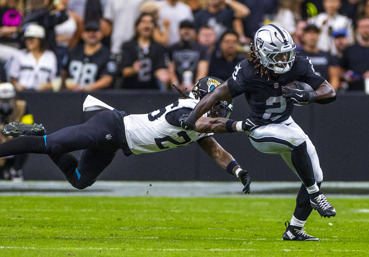 Raiders running back Ashton Jeanty (2) breaks away from Jacksonville Jaguars safety Antonio Joh ...
