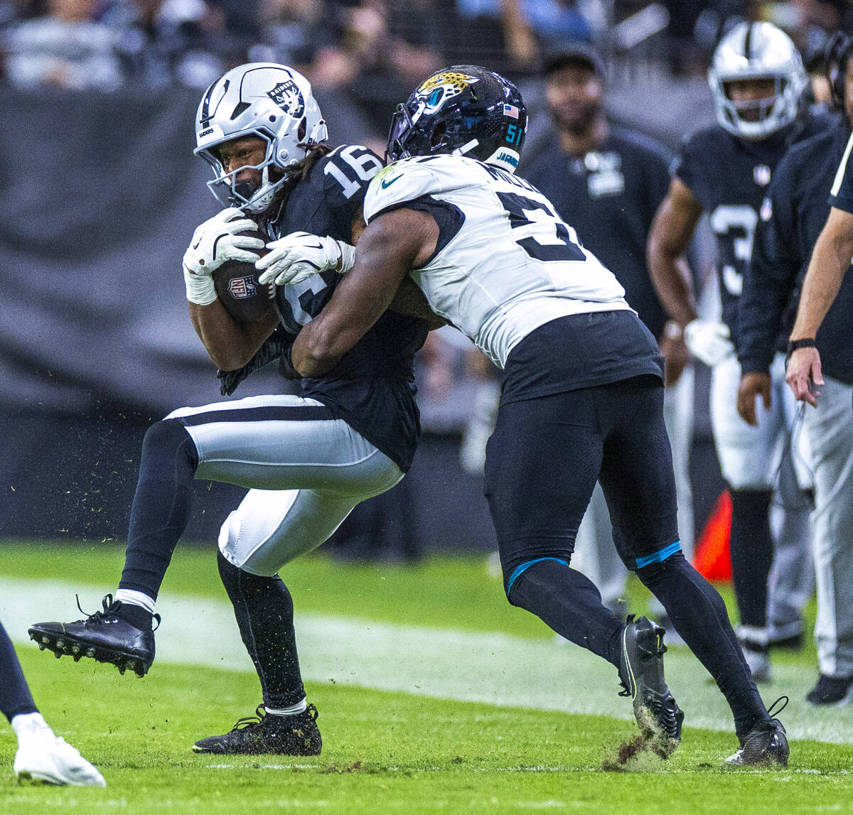 Raiders wide receiver Jakobi Meyers (16) secures a catch as Jacksonville Jaguars linebacker Ven ...