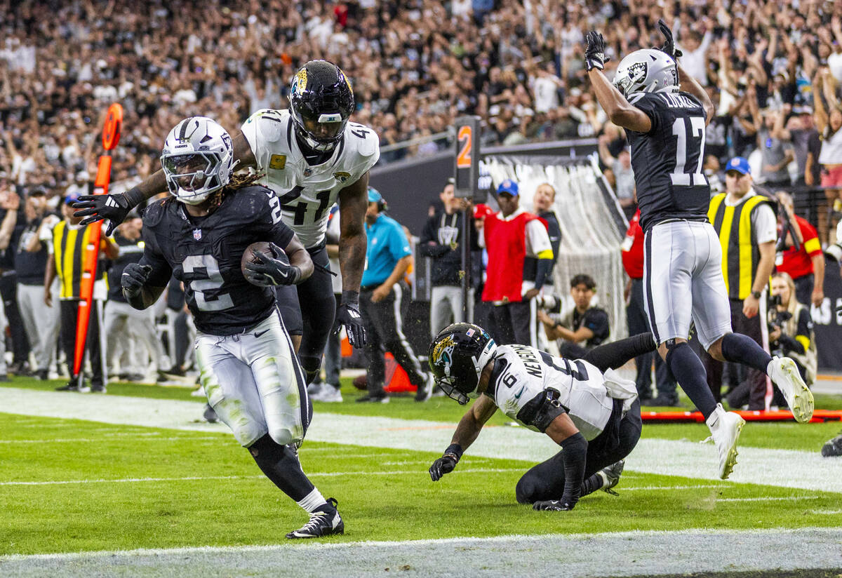 Raiders running back Ashton Jeanty (2) breaks a tackle attempt by Jacksonville Jaguars defensiv ...