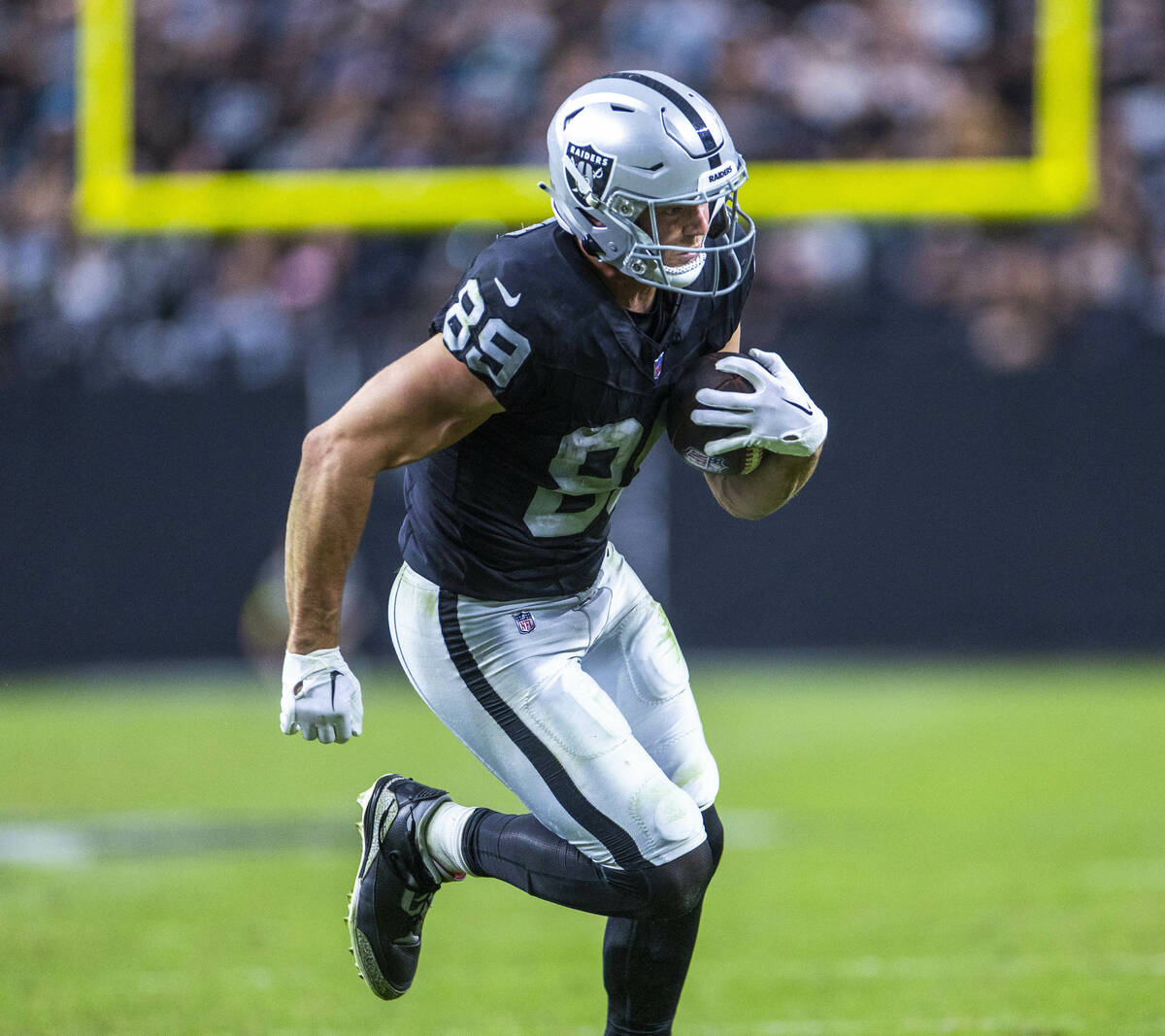Raiders tight end Brock Bowers (89) heads to the end zone after barking a tackle attempt by the ...