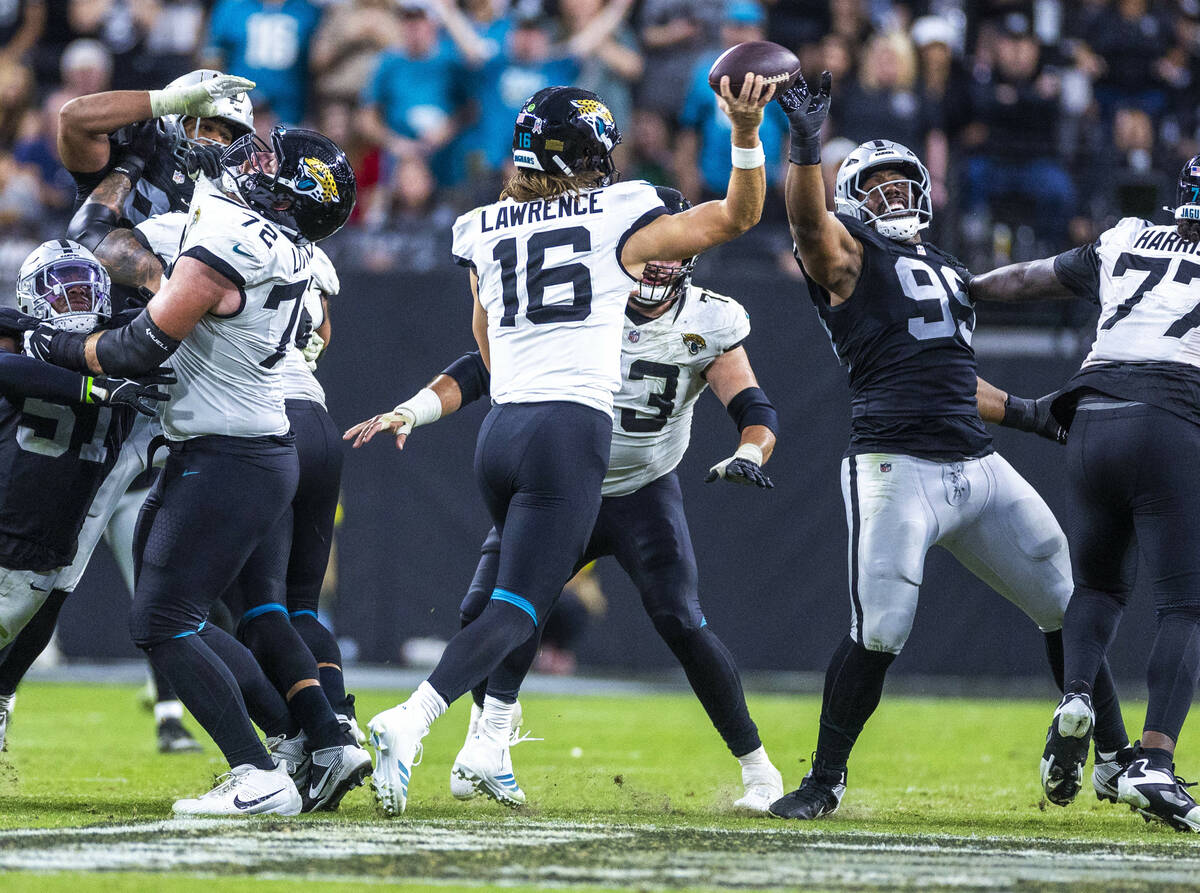 Raiders defensive tackle Thomas Booker IV (99) gets a hand on a pass attempt by Jacksonville Ja ...