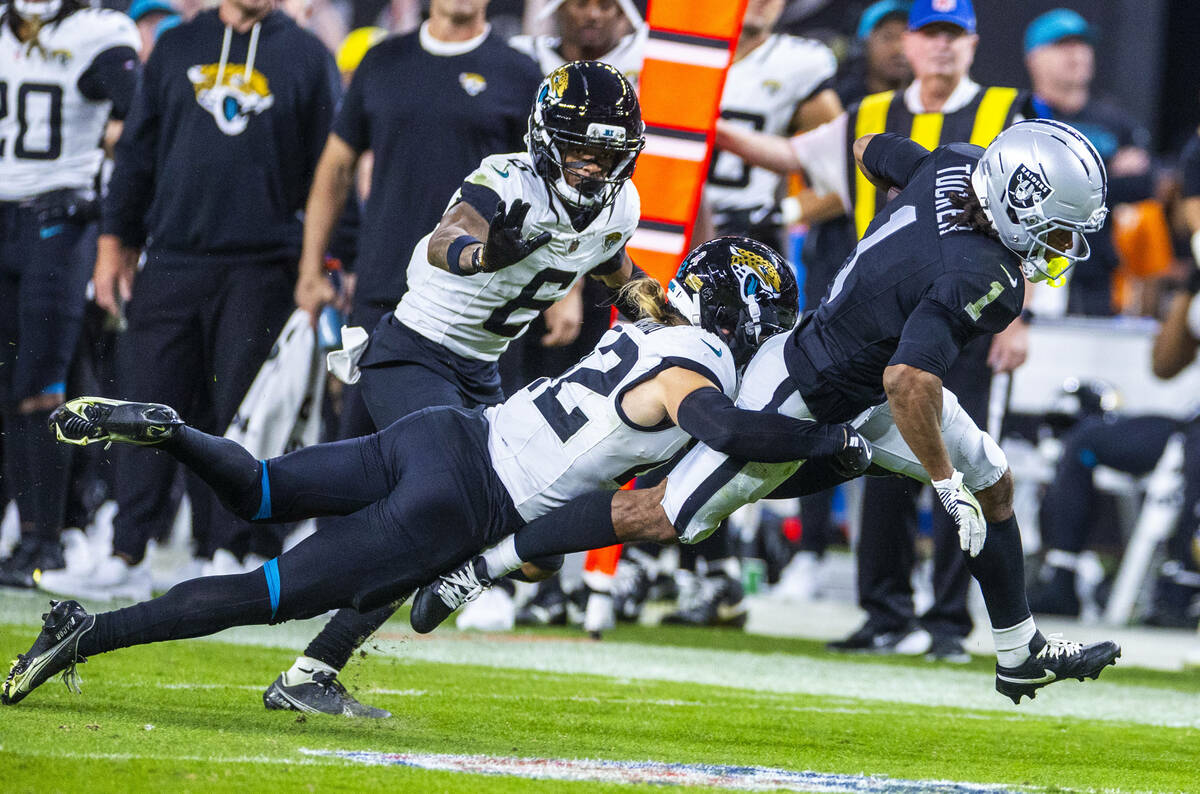Raiders wide receiver Tre Tucker (1) fights for yards after a catch with Jacksonville Jaguars s ...