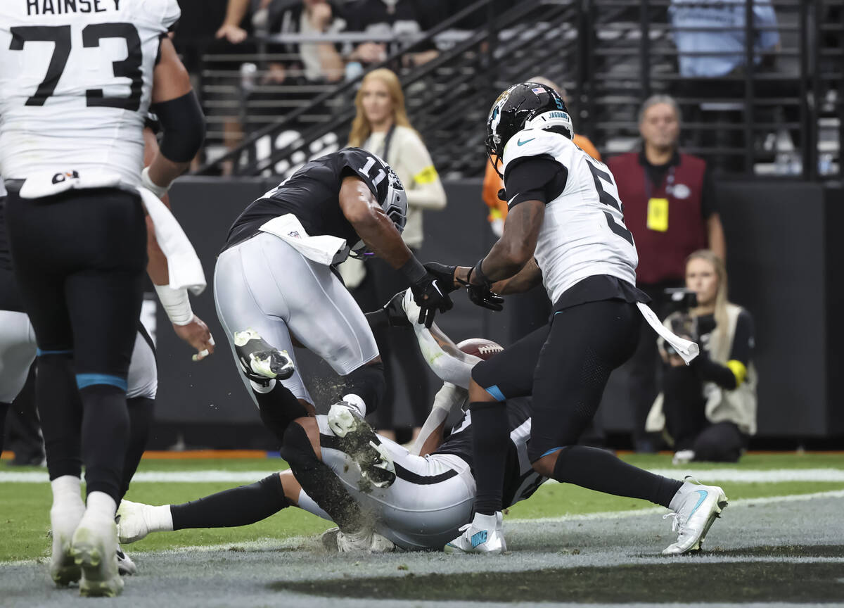 Raiders safety Isaiah Pola-Mao (20) intercepts a pass intended for Jacksonville Jaguars wide re ...