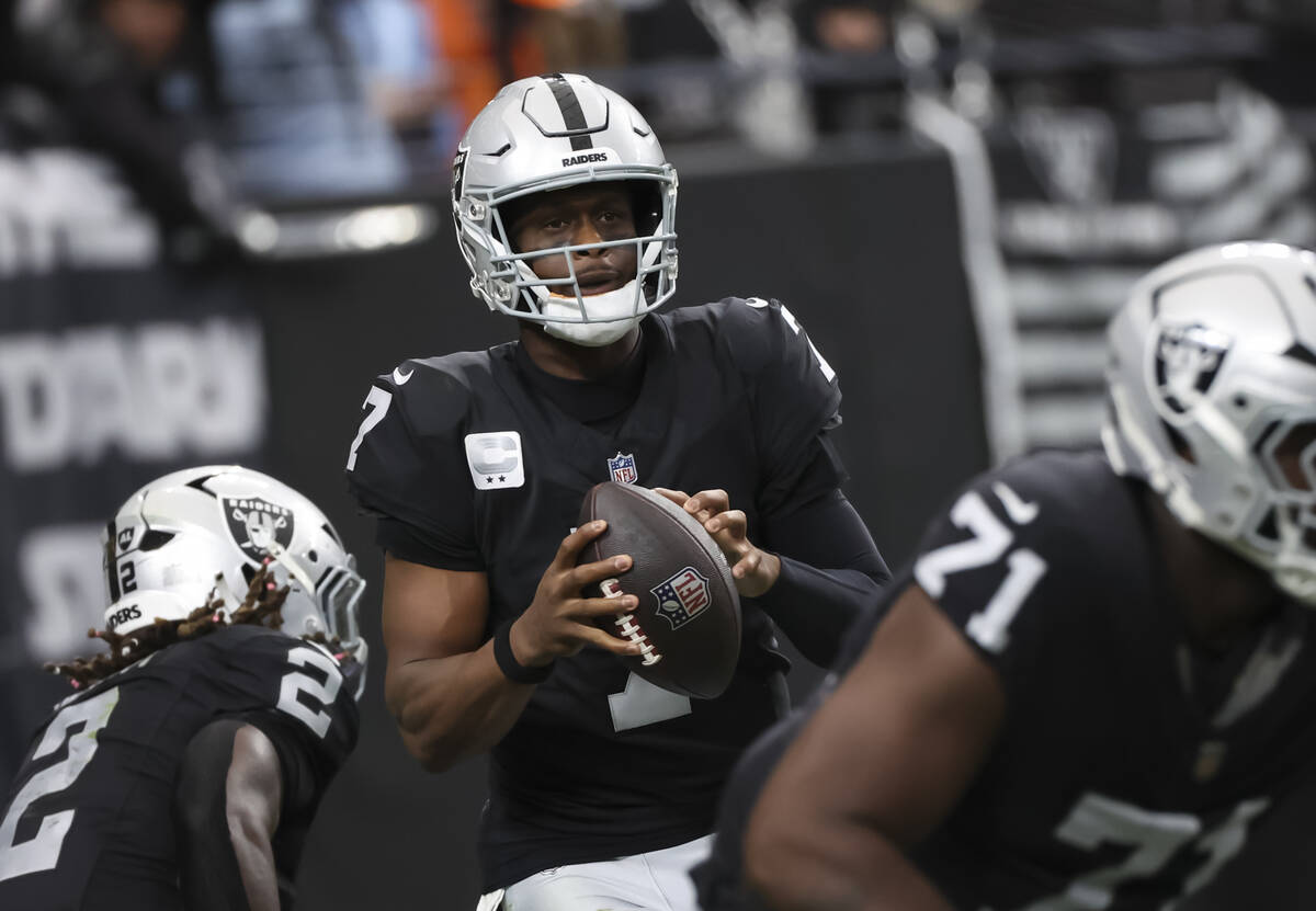 Raiders quarterback Geno Smith (7) looks to throw a pass during the first half of an NFL game a ...