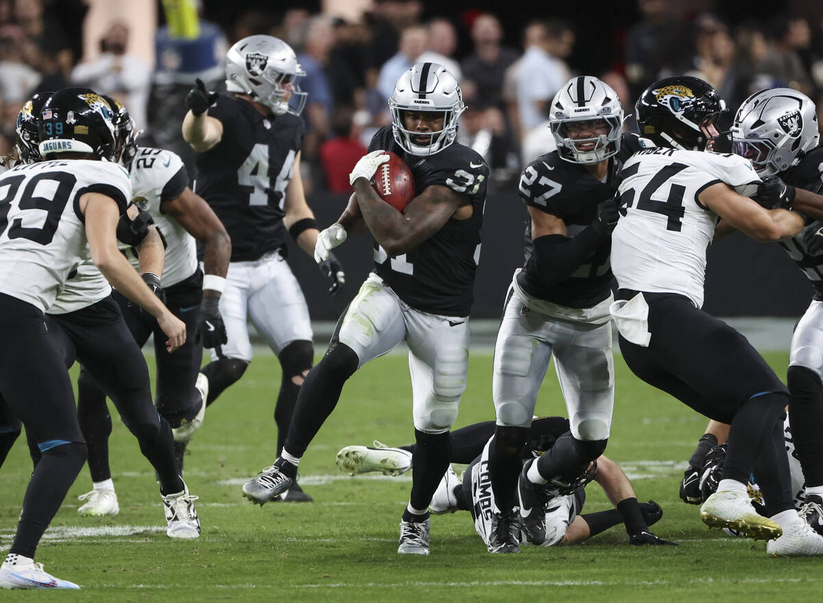 Raiders running back Raheem Mostert (31) runs the ball against the Jacksonville Jaguars during ...