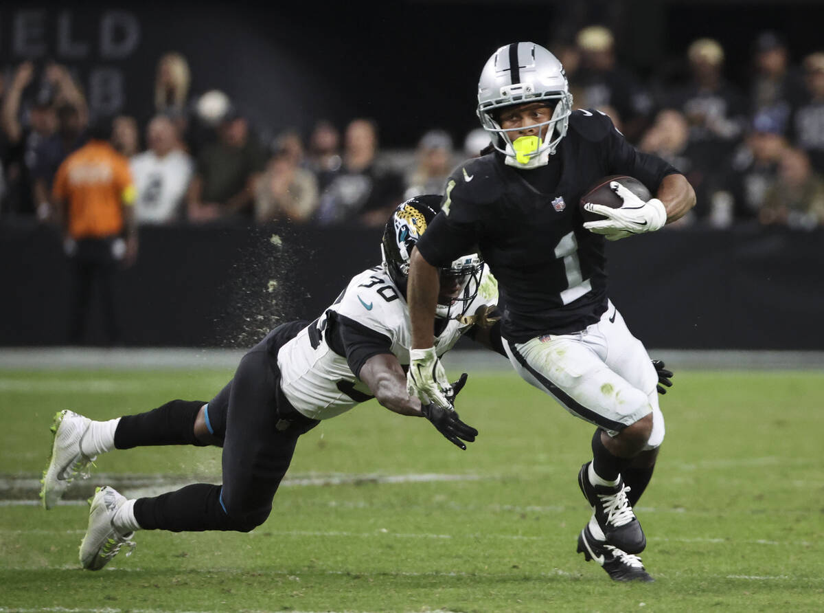 Raiders wide receiver Tre Tucker (1) runs the ball as Jacksonville Jaguars cornerback Montaric ...