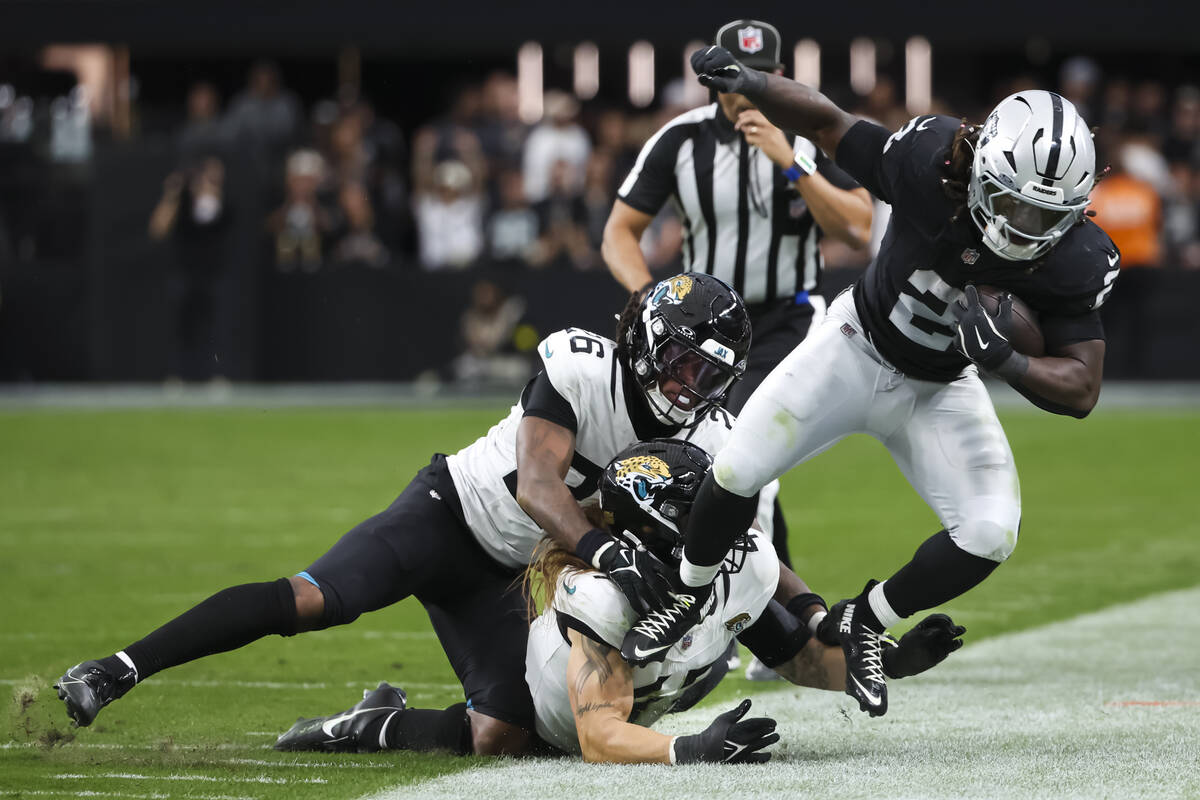 Raiders running back Ashton Jeanty (2) gets forced out of bounds by Jacksonville Jaguars lineba ...