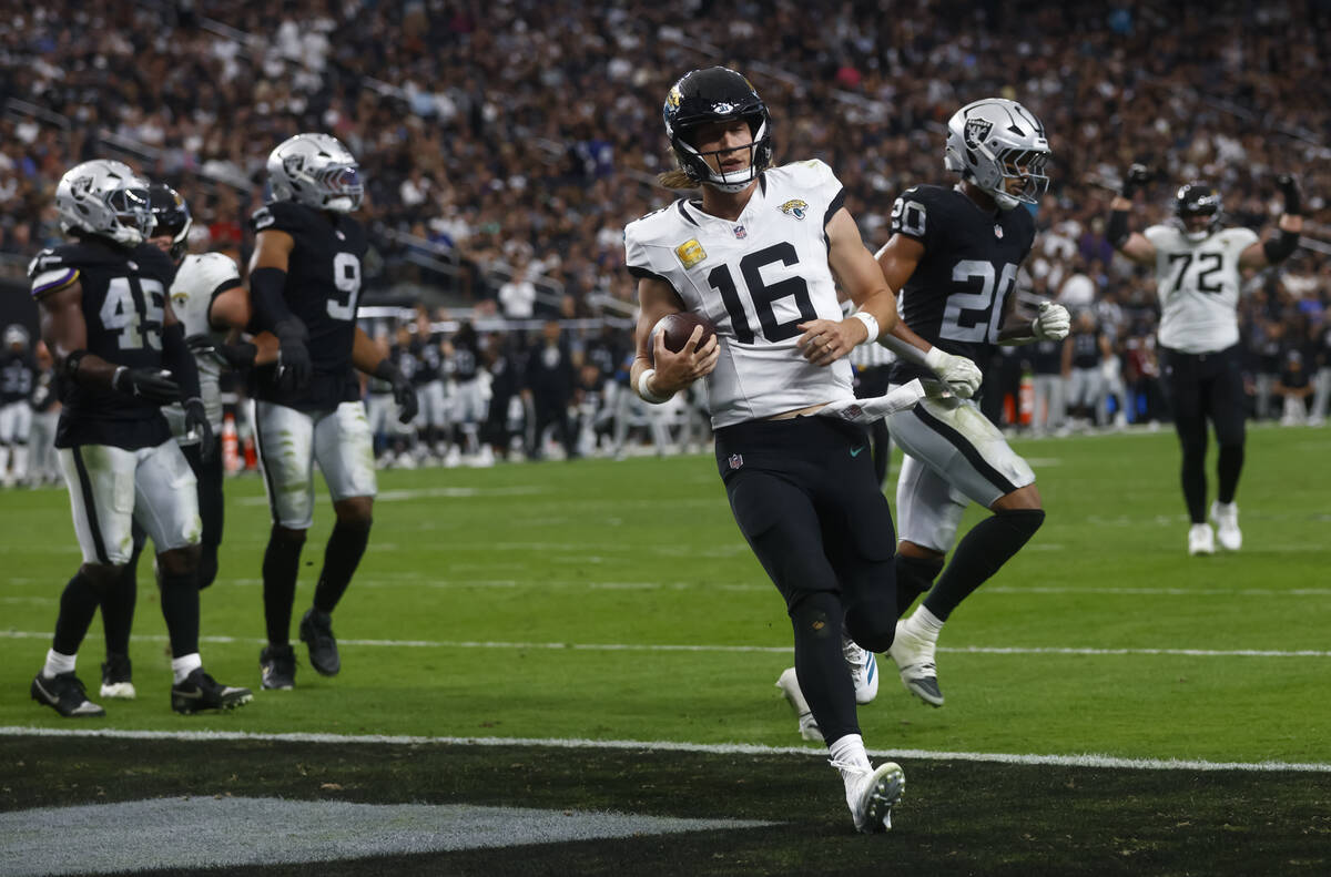 Jacksonville Jaguars quarterback Trevor Lawrence (16) scores a touchdown against the Raiders du ...