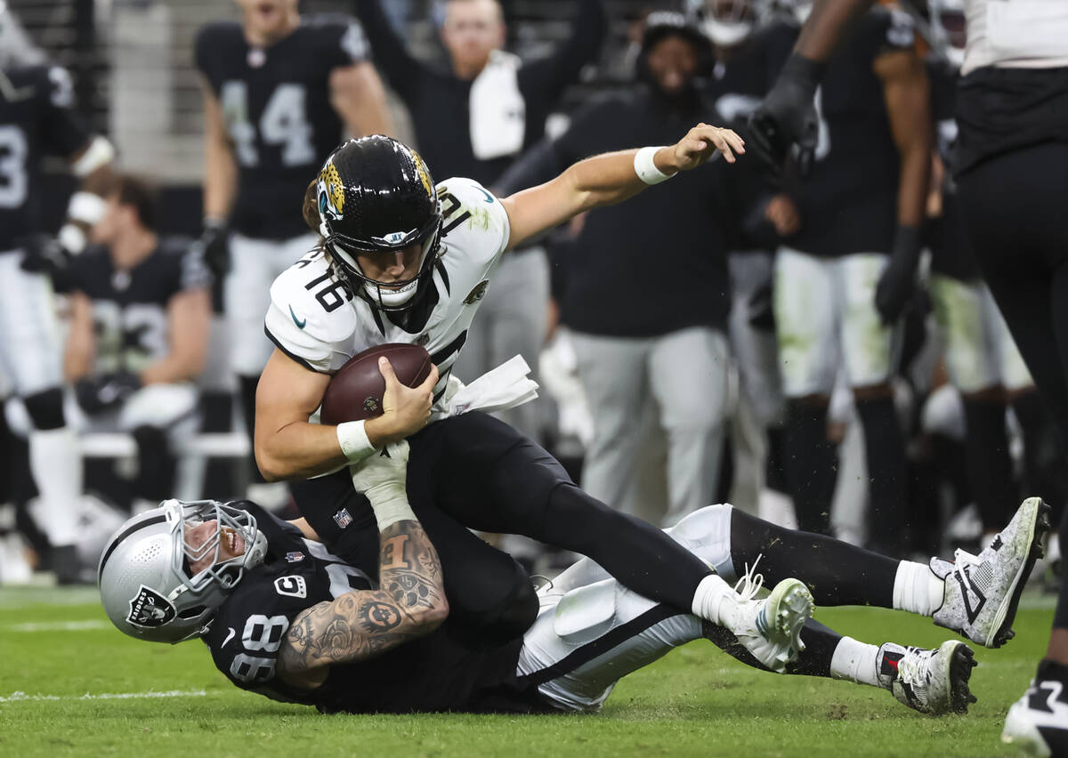 Raiders defensive end Maxx Crosby (98) sacks Jacksonville Jaguars quarterback Trevor Lawrence ( ...