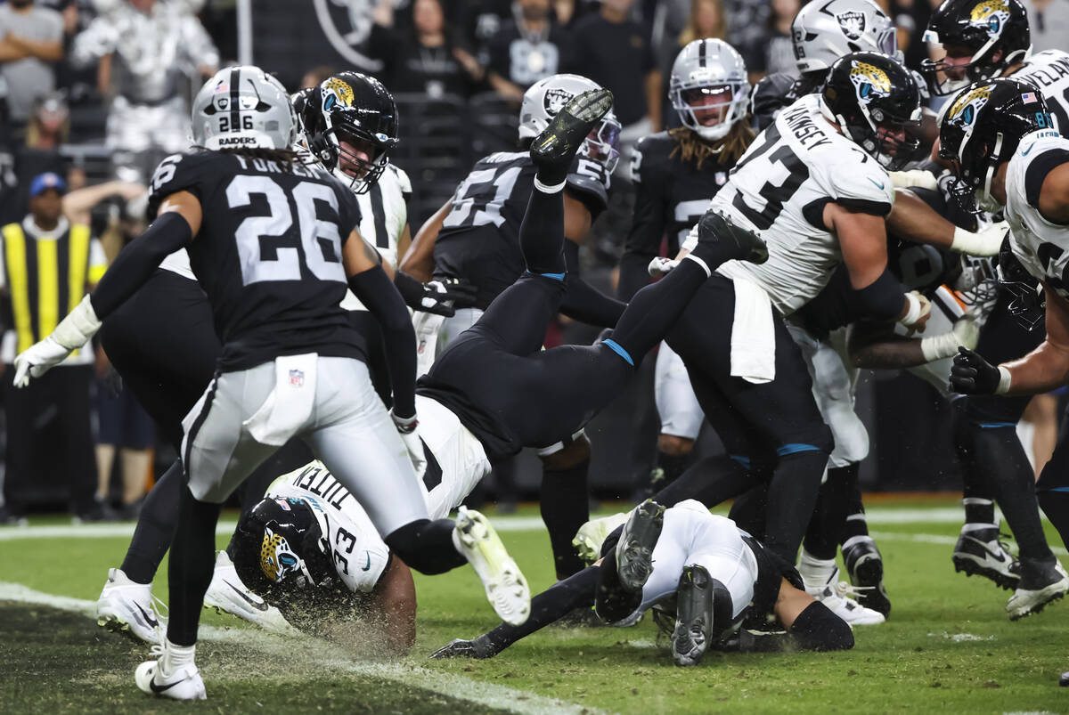 Jacksonville Jaguars running back Bhayshul Tuten (33) dives into the end zone to score a touchd ...
