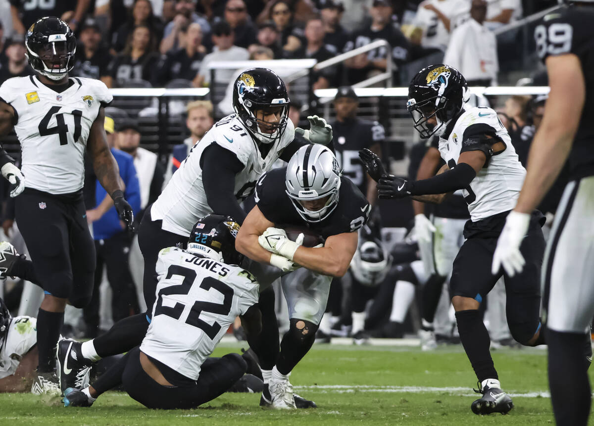 Raiders tight end Michael Mayer (87) gets stopped by Jacksonville Jaguars cornerback Jarrian Jo ...