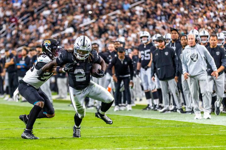Raiders running back Ashton Jeanty (2) breaks a tackle attempt by Jacksonville Jaguars safety A ...