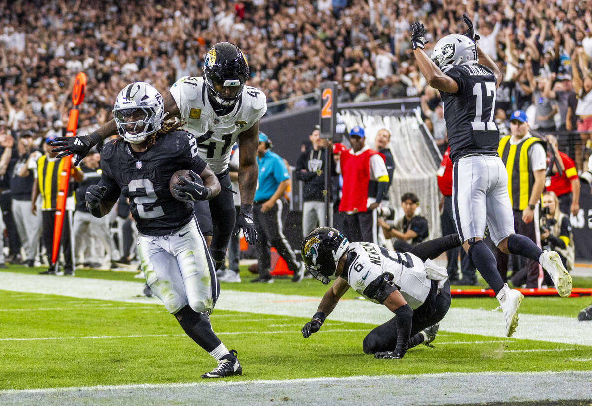 Raiders running back Ashton Jeanty (2) breaks a tackle attempt by Jacksonville Jaguars defensiv ...