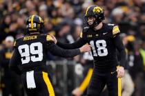 Iowa kicker Drew Stevens (18) celebrates with teammate Ty Nissen (99) after kicking a field goa ...