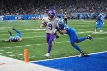 Minnesota Vikings quarterback J.J. McCarthy (9) scores a touchdown ahead of Detroit Lions safet ...