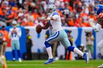 Dallas Cowboys quarterback Dak Prescott scrambles against the Denver Broncos during an NFL foot ...