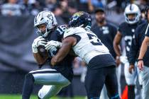 Raiders wide receiver Jakobi Meyers (16) secures a catch as Jacksonville Jaguars linebacker Ven ...