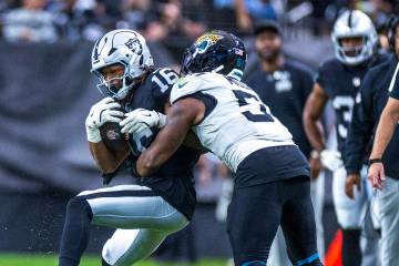 Raiders wide receiver Jakobi Meyers (16) secures a catch as Jacksonville Jaguars linebacker Ven ...