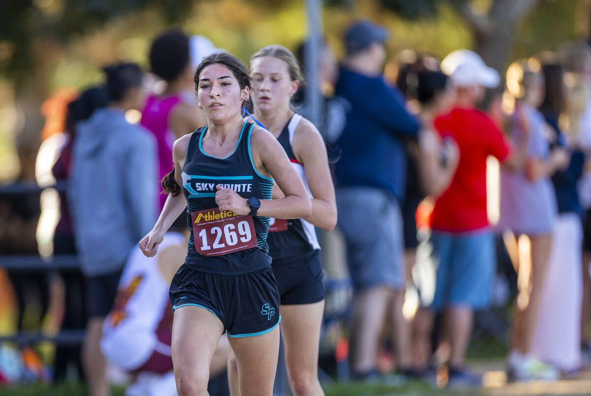 Somerset Academy Sky Pointe High School runner Aislin McMahon (1269) leads halfway in the ...