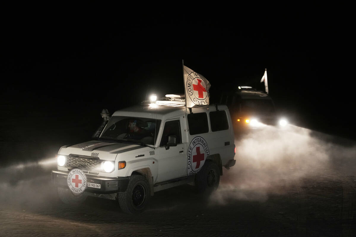 Red Cross vehicles carrying the bodies of three people believed to be deceased hostages handed ...