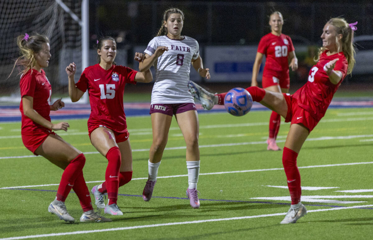 Coronado's Ella Schultz (4) and Jovie Poniewaz (15) with Faith Lutheran's Olivia Sta ...