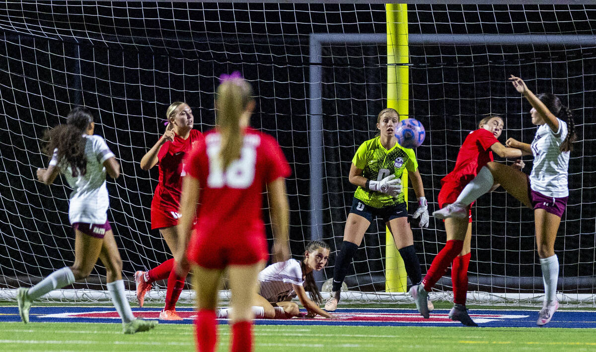 Coronado goalie Lilian Foss (0) eyes a kick by Faith Lutheran's Ana Coe (11) during the se ...