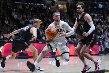 Purdue guard Braden Smith (3) drives between UIndy guard Ethan Edwards (32) and UIndy forward E ...