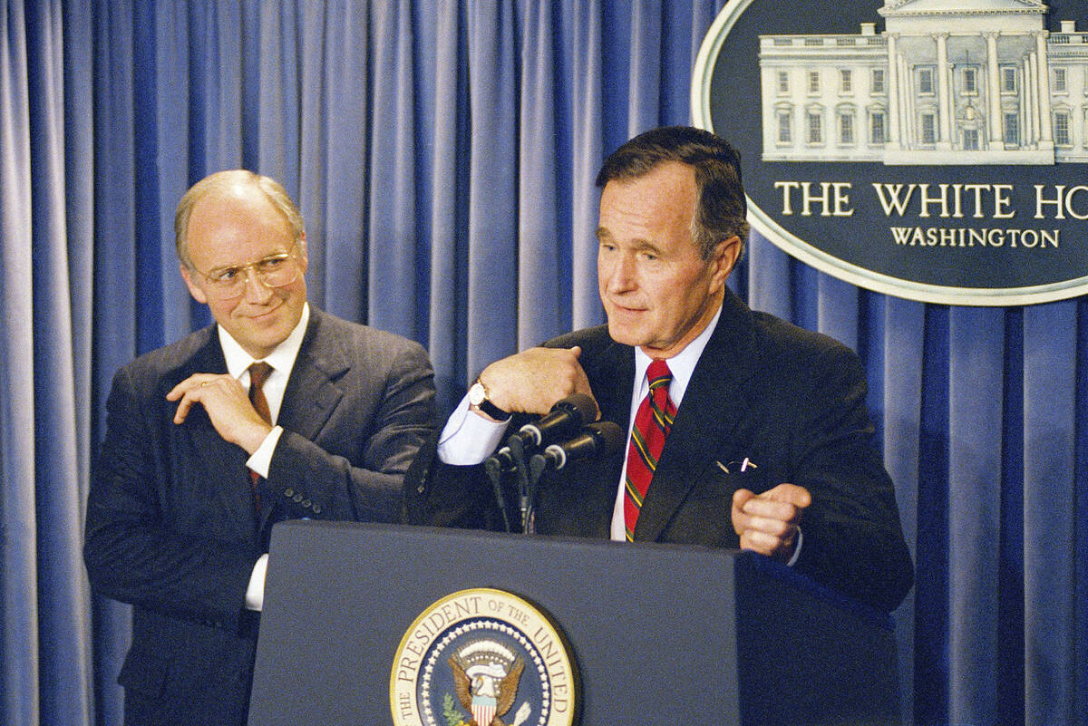 President George H.W. Bush gestures during a news conference at the White House on Friday, Marc ...