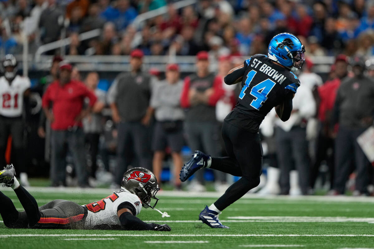 Detroit Lions wide receiver Amon-Ra St. Brown (14) runs for a touchdown after making a catch ag ...
