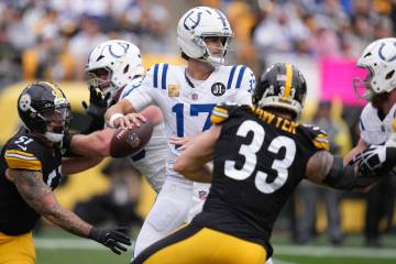 Indianapolis Colts quarterback Daniel Jones (17) looks to pass during an NFL football game agai ...