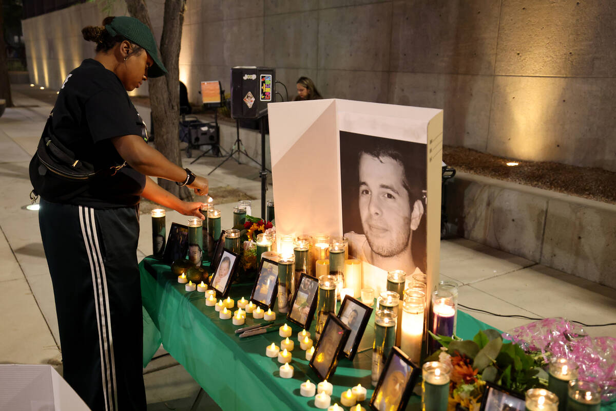 Tori, who declined to give her last name, with More Than A Hashtag, lights candles during a vig ...