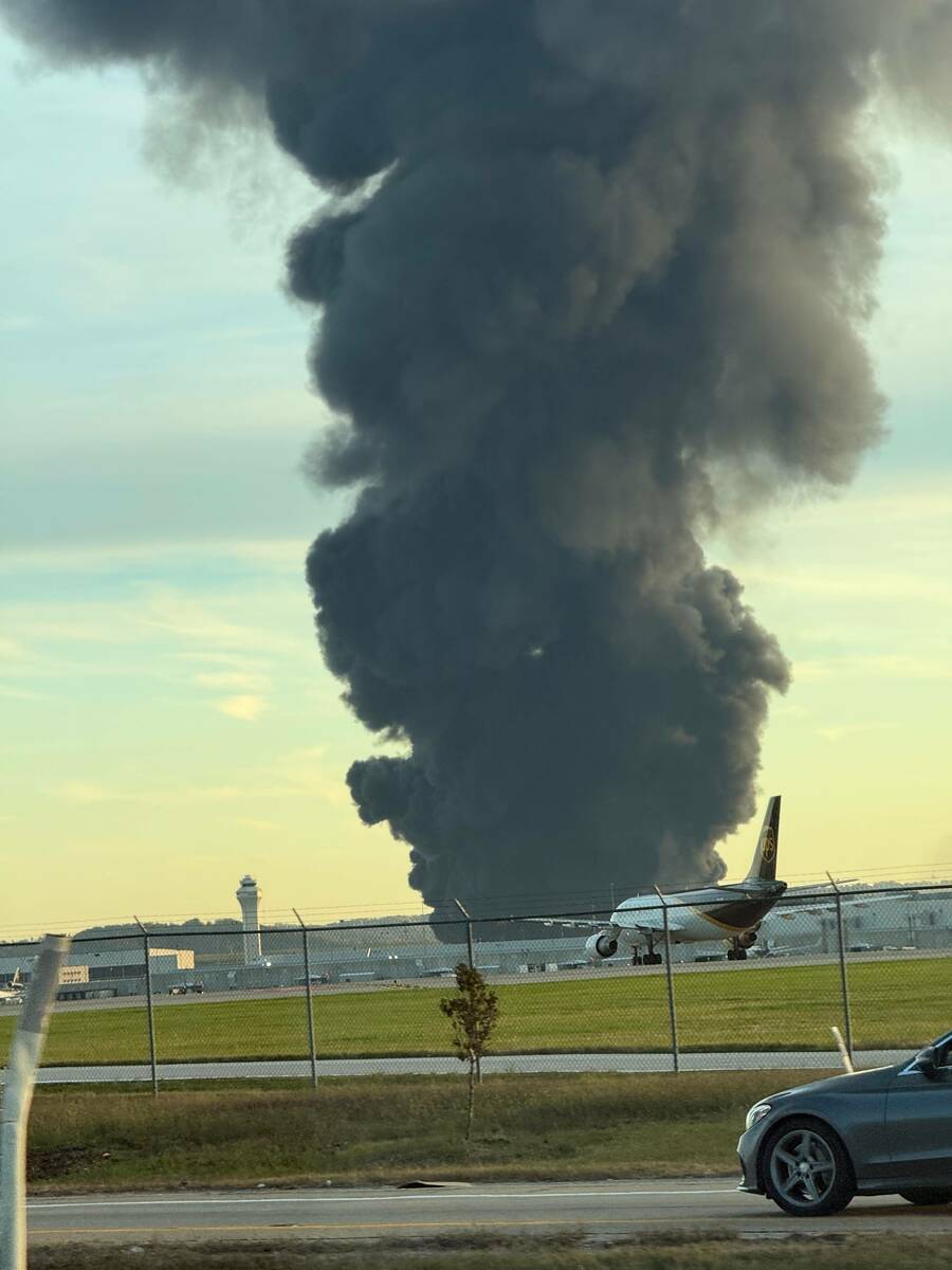 This photo provided by Brad Harvey shows thick, black smoke rising after reports of a plane cra ...