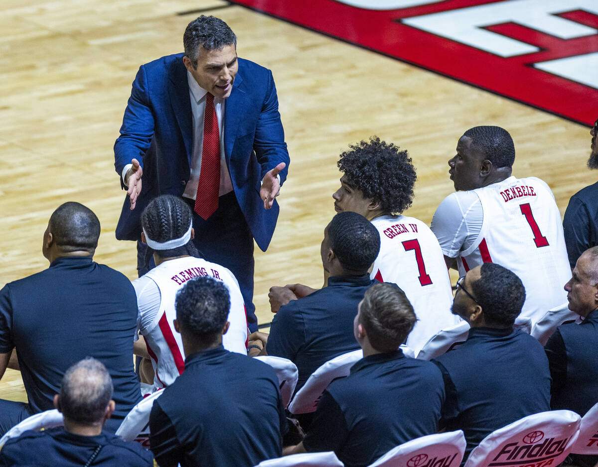 UNLV head coach Josh Pastner talks with his players as on the bench during the first half of th ...