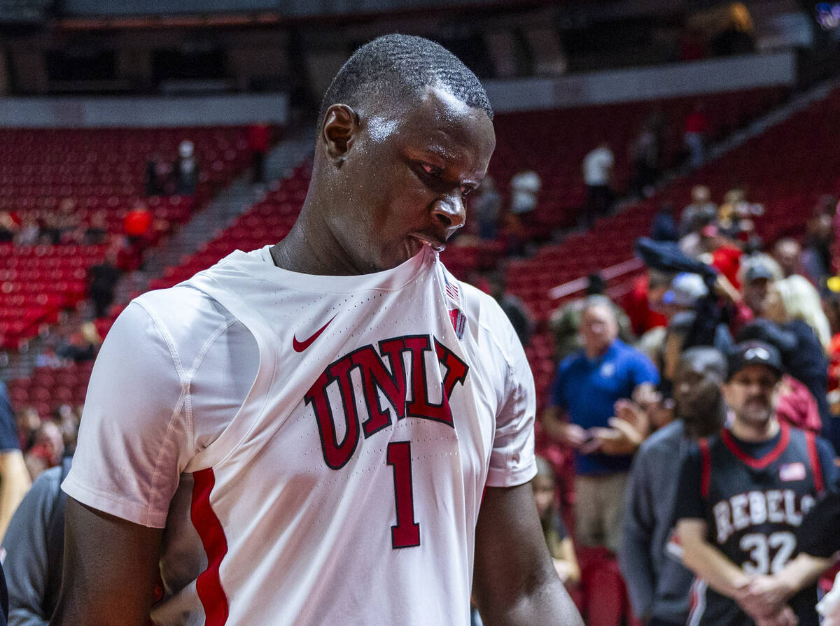 UNLV forward Ladji Dembele (1) is a bit disappointed as he leaves the court in a loss to the UT ...