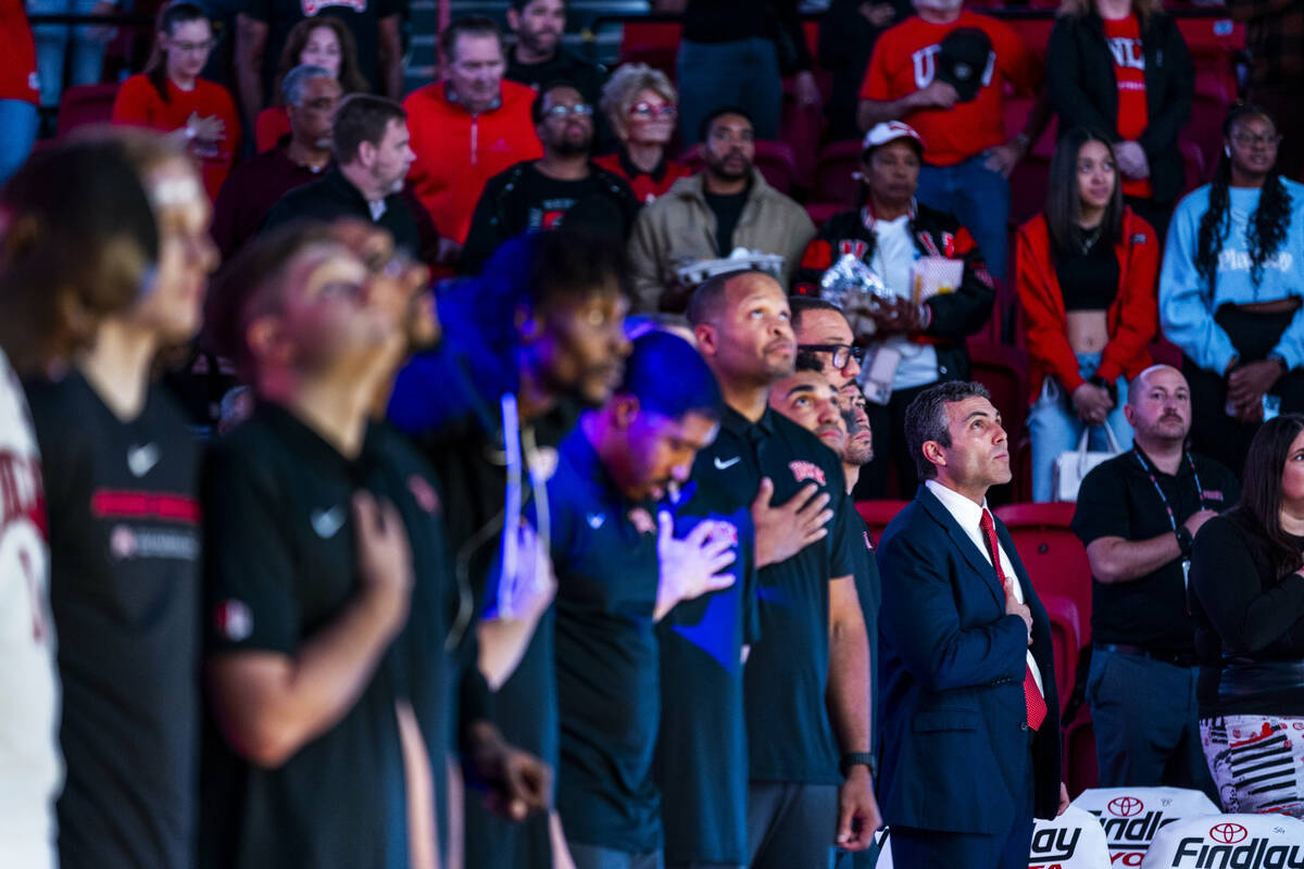 UNLV head coach Josh Pastner joins his players for the National Anthem as they take on the UT M ...