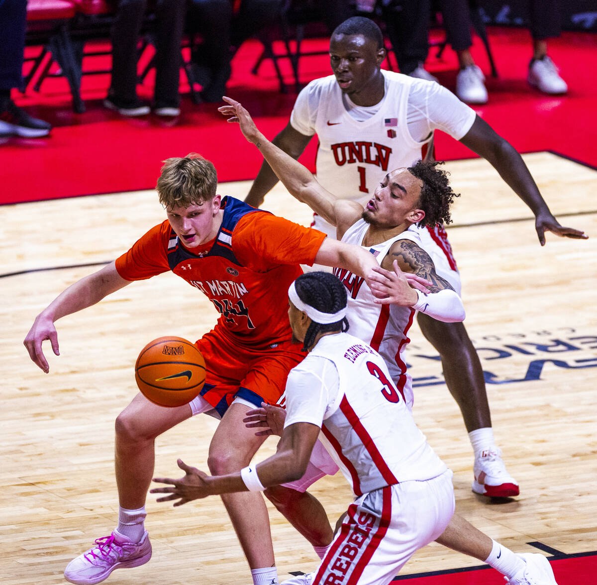 UNLV guard Howie Fleming Jr. (3) reaches for a loose ball taken from UT Martin Skyhawks forward ...
