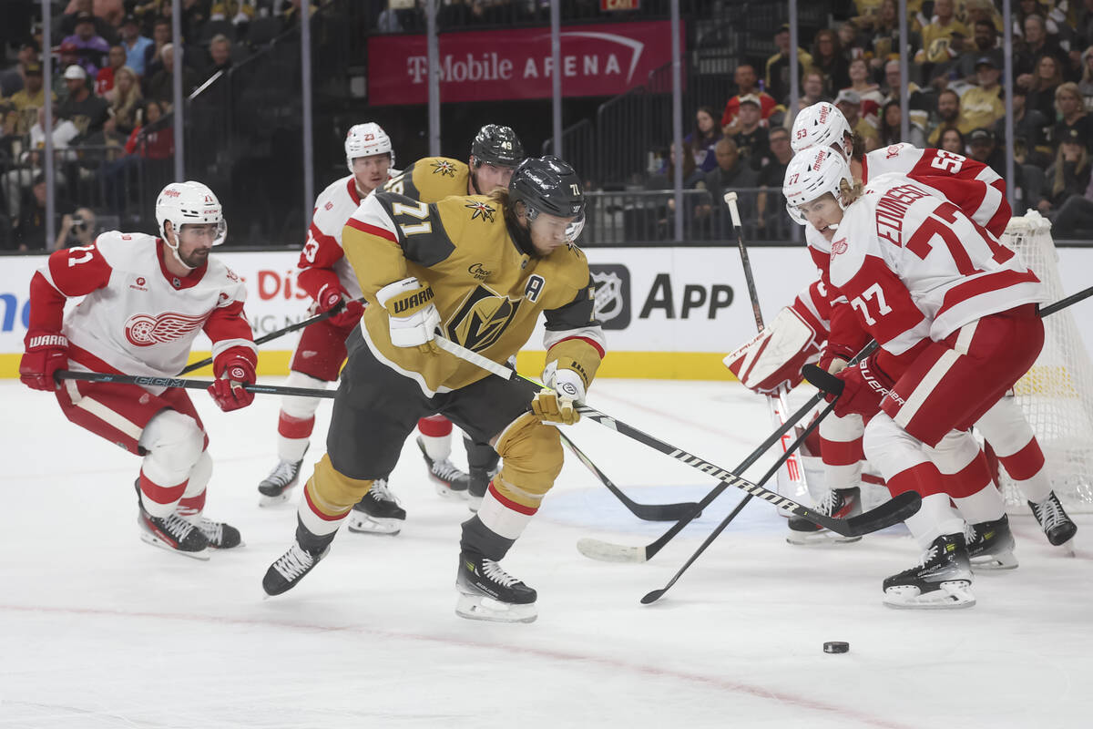 Golden Knights center William Karlsson (71) and Detroit Red Wings defenseman Simon Edvinsson (7 ...