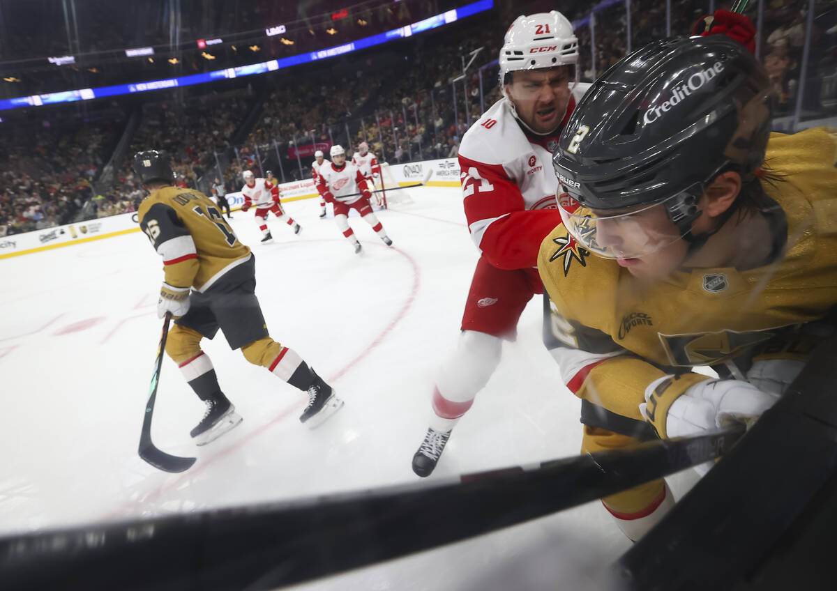 Detroit Red Wings left wing James van Riemsdyk (21) pushes Golden Knights defenseman Zach White ...