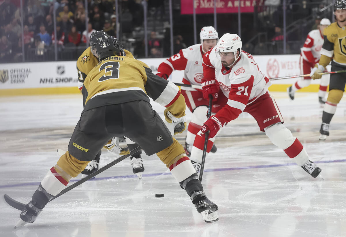 Detroit Red Wings center Dylan Larkin (71) passes the puck as Golden Knights defenseman Brayden ...