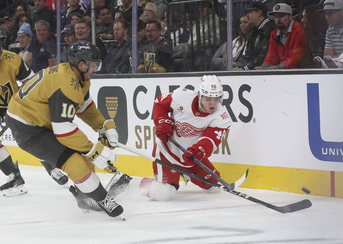 Detroit Red Wings right wing Jonatan Berggren (48) passes the puck under pressure from Golden K ...